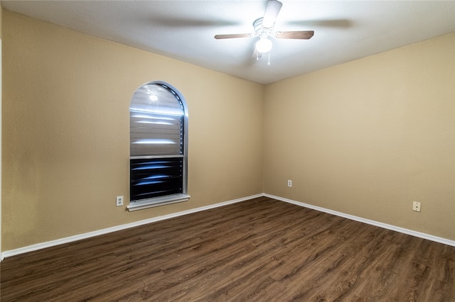 spare room featuring dark hardwood / wood-style floors and ceiling fan