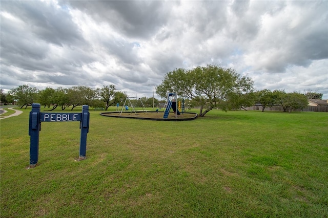 surrounding community featuring a playground and a lawn