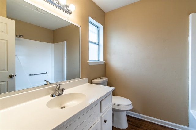 bathroom featuring hardwood / wood-style floors, vanity, and toilet