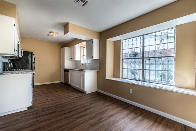 kitchen with dark hardwood / wood-style flooring, decorative backsplash, sink, stainless steel dishwasher, and white cabinetry