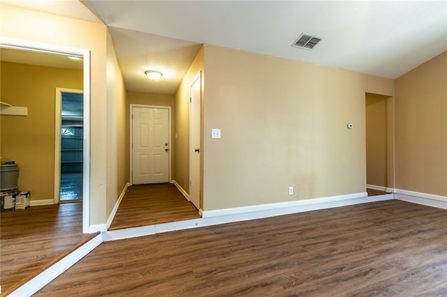 empty room with dark hardwood / wood-style floors