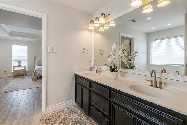 bathroom featuring a sink, baseboards, and visible vents