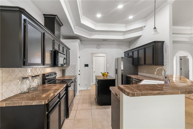 kitchen featuring stainless steel fridge, a sink, arched walkways, a peninsula, and black / electric stove