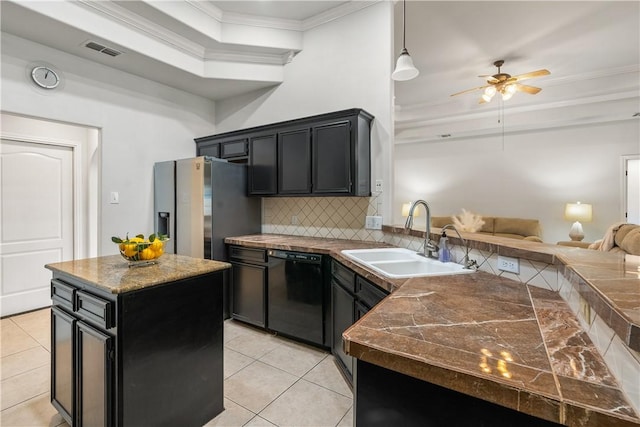 kitchen featuring black dishwasher, dark cabinets, light tile patterned flooring, and a sink