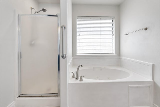full bath featuring a shower stall and a jetted tub