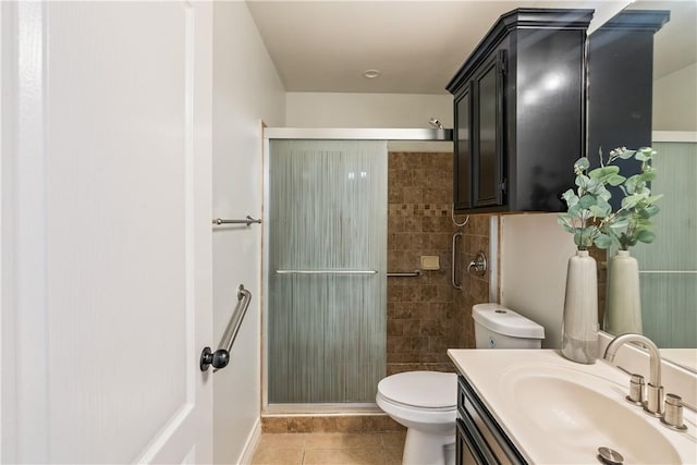 bathroom featuring vanity, toilet, tile patterned floors, baseboards, and a shower stall