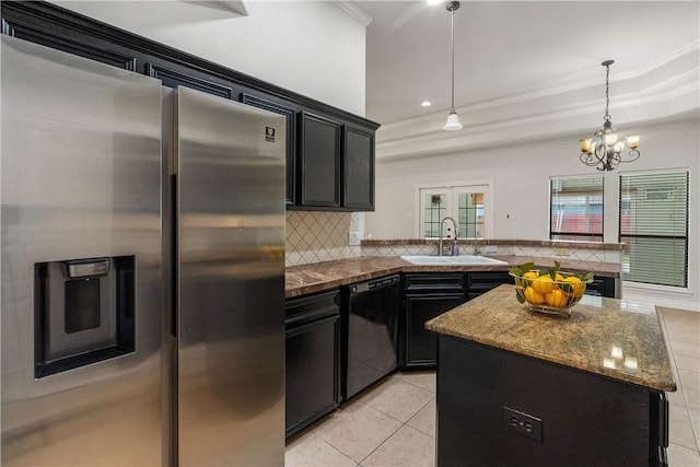 kitchen featuring stainless steel fridge, a sink, dark cabinetry, and dishwasher