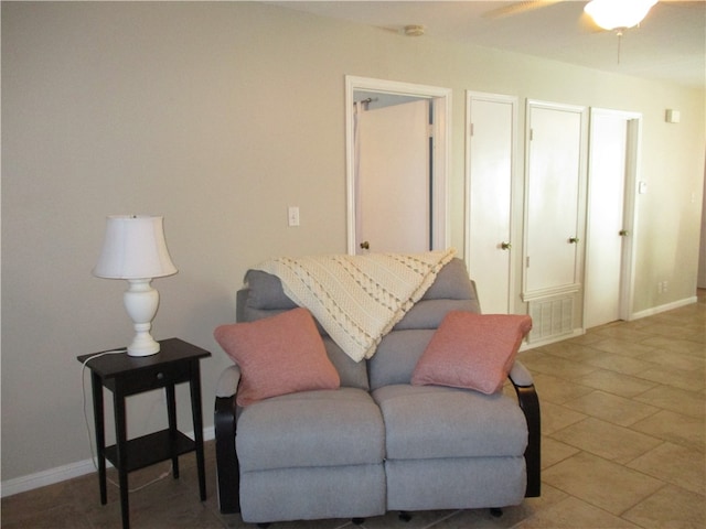 sitting room featuring tile patterned floors and ceiling fan