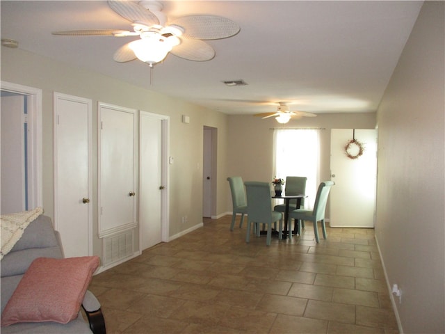 dining area featuring ceiling fan and tile patterned floors