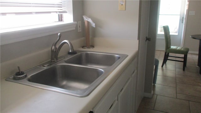 kitchen featuring a wealth of natural light, sink, and tile patterned flooring