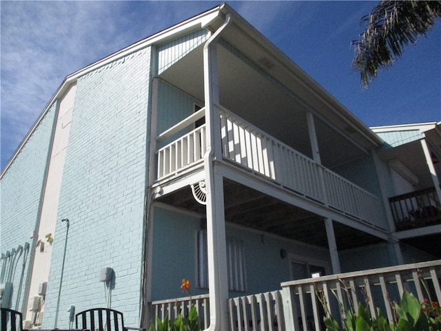 view of side of home featuring a balcony