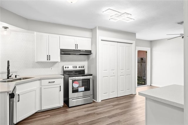 kitchen with light hardwood / wood-style flooring, sink, stainless steel appliances, and white cabinetry