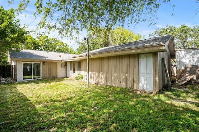 rear view of property featuring a yard