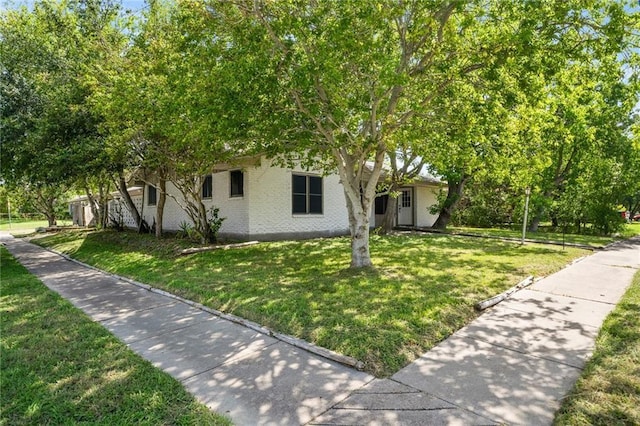 obstructed view of property featuring a front yard