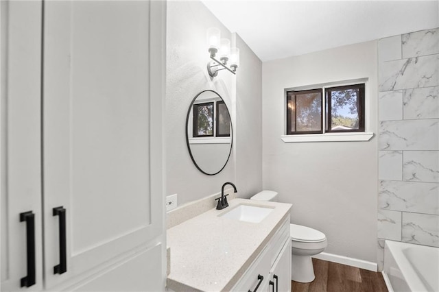 full bathroom featuring toilet, vanity, hardwood / wood-style floors, and shower / bathing tub combination