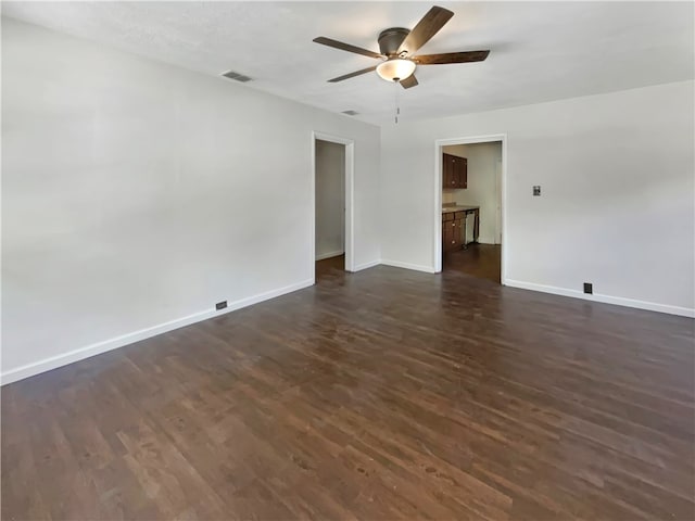 empty room with dark hardwood / wood-style floors and ceiling fan