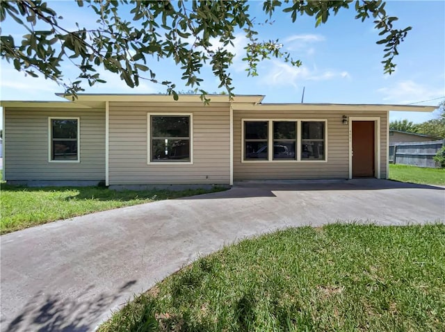 4053 Little John Dr, Corpus Christi, TX 78411 - single story home featuring a front lawn, a patio, and driveway