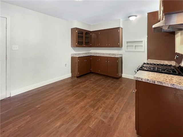 4053 Little John Dr, Corpus Christi, TX 78411 - kitchen with gas stove, exhaust hood, light countertops, dark brown cabinets, and dark wood-style floors