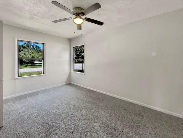 4053 Little John Dr, Corpus Christi, TX 78411 - carpeted empty room with plenty of natural light, baseboards, a ceiling fan, and a textured ceiling