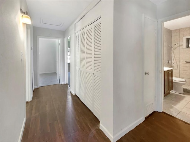 4053 Little John Dr, Corpus Christi, TX 78411 - hall featuring dark wood-type flooring, attic access, and baseboards
