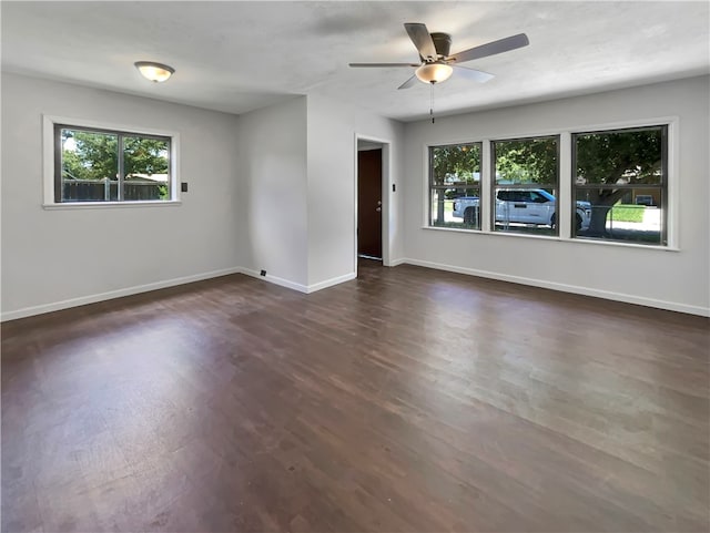 spare room featuring dark wood-type flooring and ceiling fan