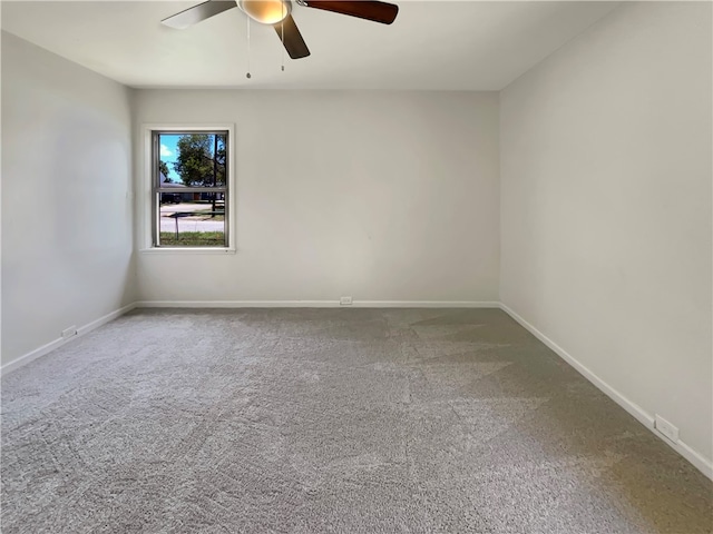 carpeted spare room featuring ceiling fan