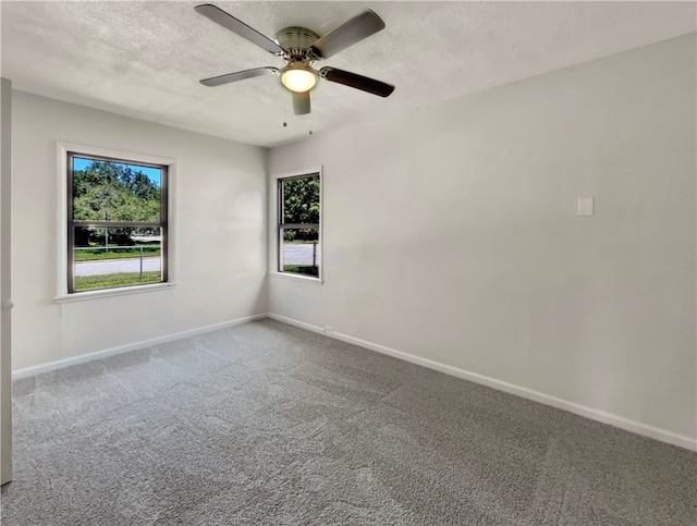 carpeted empty room with a textured ceiling and ceiling fan