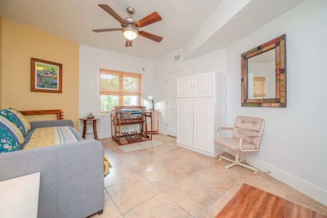 sitting room with light tile patterned floors and ceiling fan