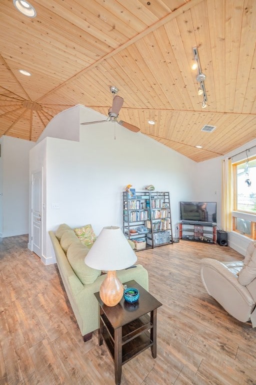 living room with vaulted ceiling, wood ceiling, rail lighting, ceiling fan, and light wood-type flooring