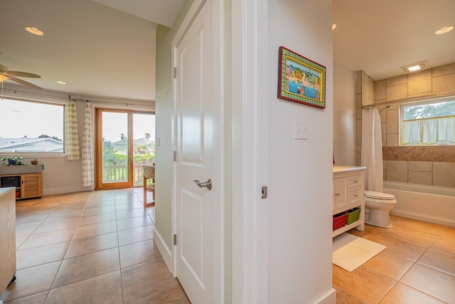 hall with light tile patterned floors