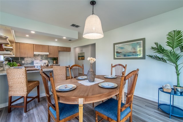 dining space featuring dark hardwood / wood-style floors