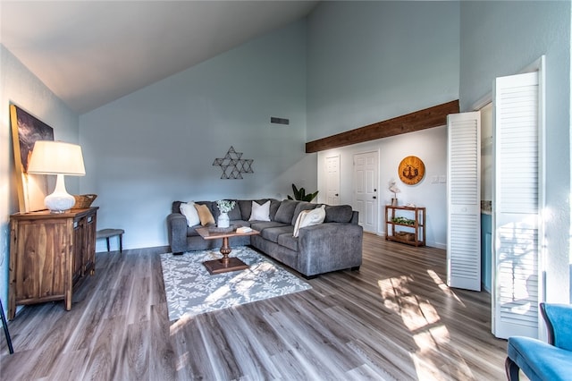 living room featuring hardwood / wood-style flooring and high vaulted ceiling