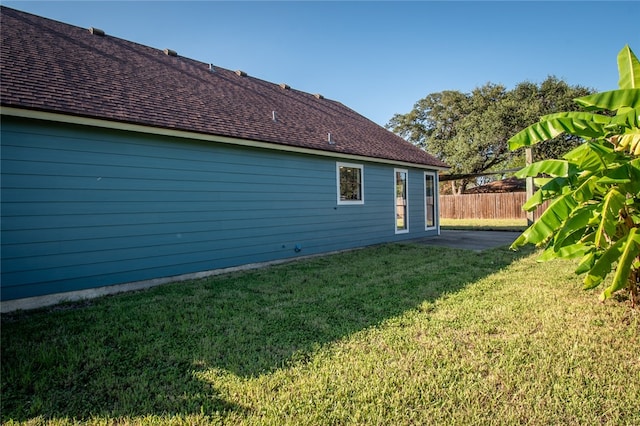 view of property exterior featuring a patio area and a yard