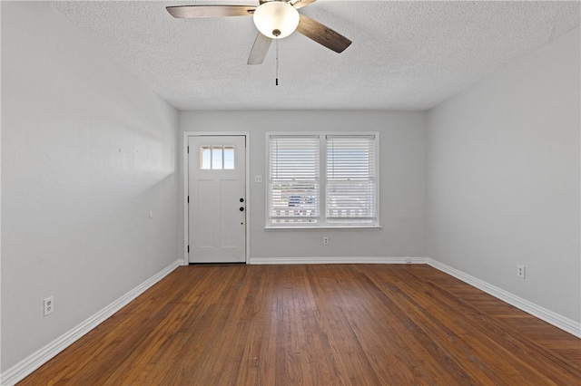 entrance foyer featuring dark wood-type flooring, a textured ceiling, and ceiling fan