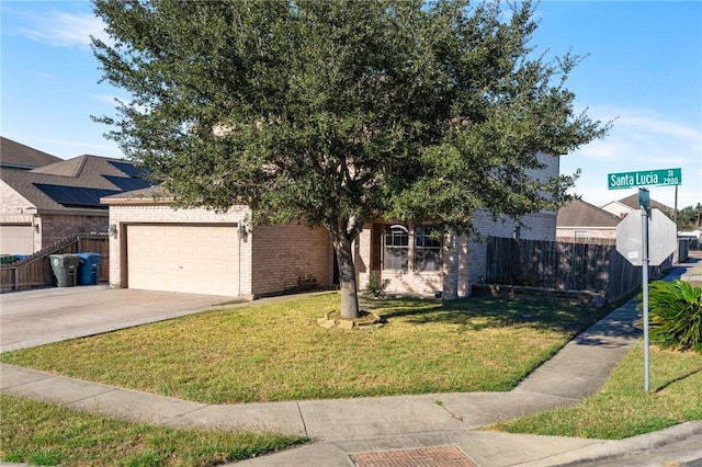 view of front of property featuring a front yard and a garage