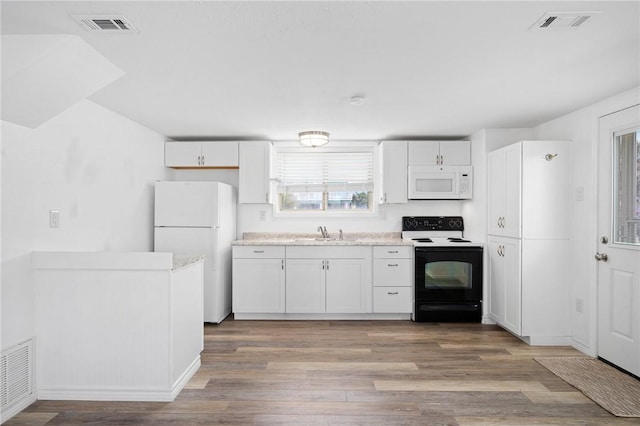 kitchen featuring white cabinets, light wood-type flooring, white appliances, and sink