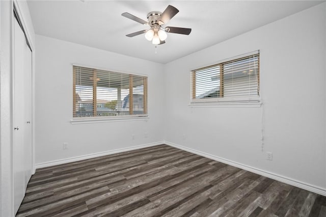 unfurnished room featuring dark hardwood / wood-style flooring, ceiling fan, and plenty of natural light