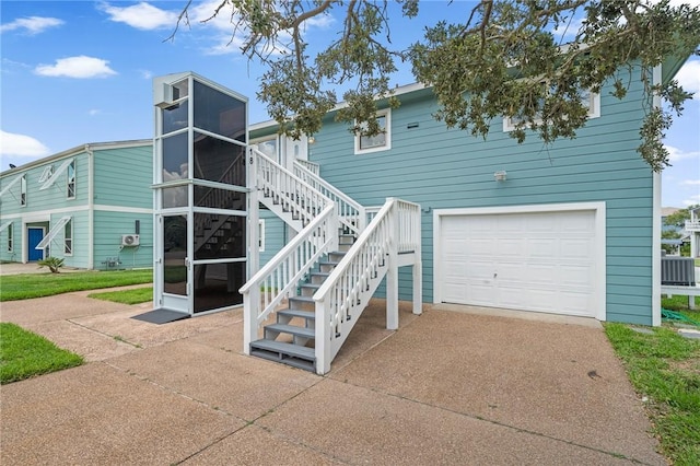 view of front of house featuring central AC and a garage