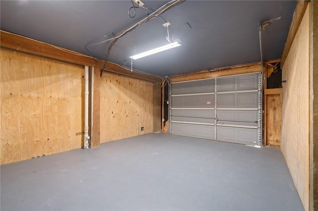 garage featuring wood walls