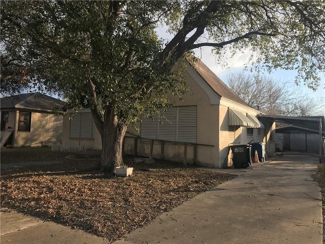 view of property exterior with a carport