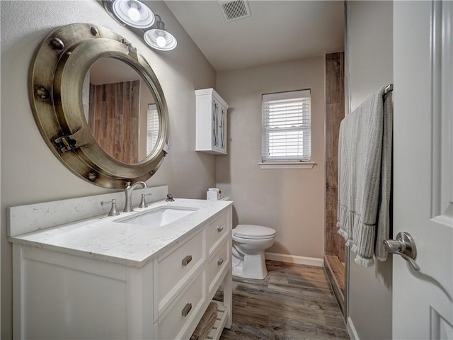14350 Aquarius St, Corpus Christi, TX 78418 - full bath with wood finished floors, vanity, toilet, and baseboards