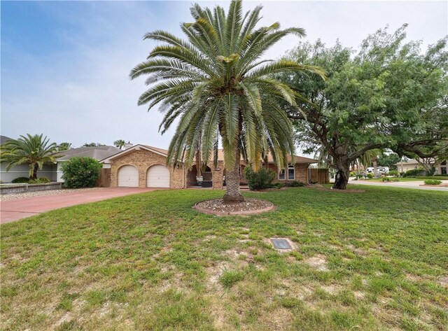 14350 Aquarius St, Corpus Christi, TX 78418 - view of front of property with concrete driveway, a garage, and a front lawn