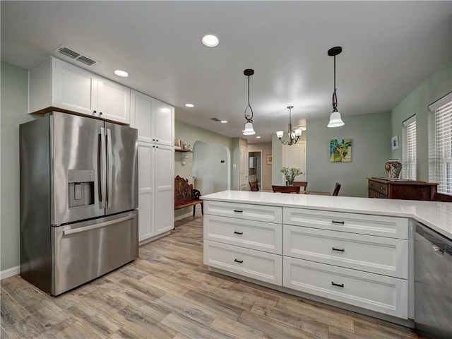 14350 Aquarius St, Corpus Christi, TX 78418 - kitchen featuring appliances with stainless steel finishes, a chandelier, white cabinetry, light countertops, and recessed lighting