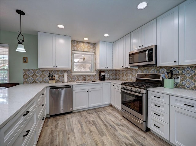 14350 Aquarius St, Corpus Christi, TX 78418 - kitchen with appliances with stainless steel finishes, a sink, healthy amount of natural light, white cabinets, and recessed lighting