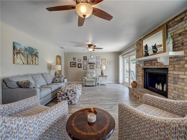 14350 Aquarius St, Corpus Christi, TX 78418 - living room featuring ceiling fan, light wood-type flooring, a fireplace, and baseboards