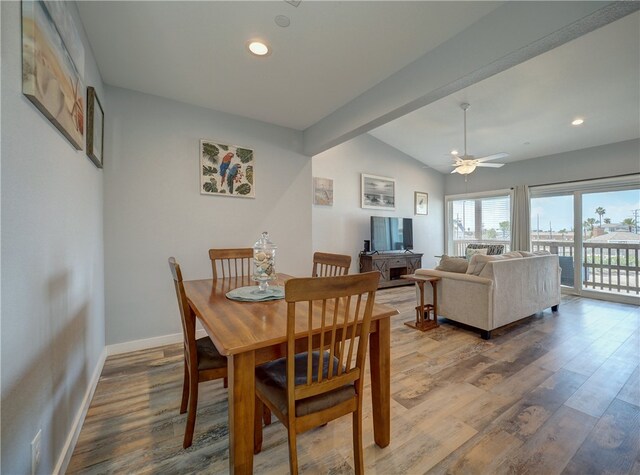 dining area featuring wood-type flooring, vaulted ceiling with beams, and ceiling fan