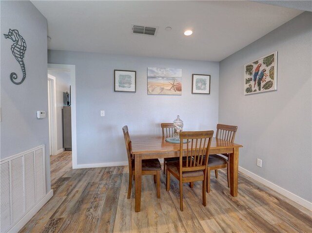 dining area with hardwood / wood-style floors