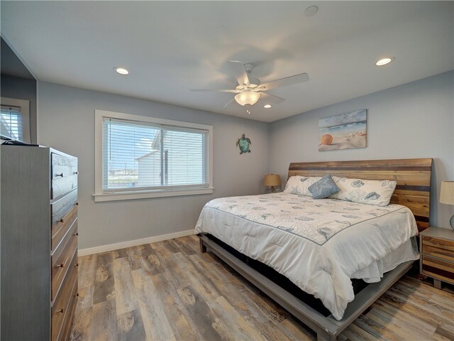 bedroom with hardwood / wood-style floors and ceiling fan