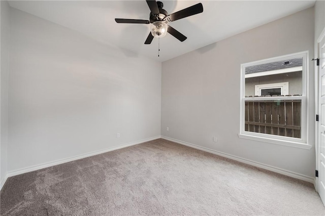 spare room with carpet floors and ceiling fan