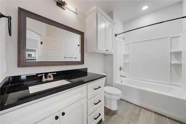 full bathroom with toilet, vanity, and washtub / shower combination